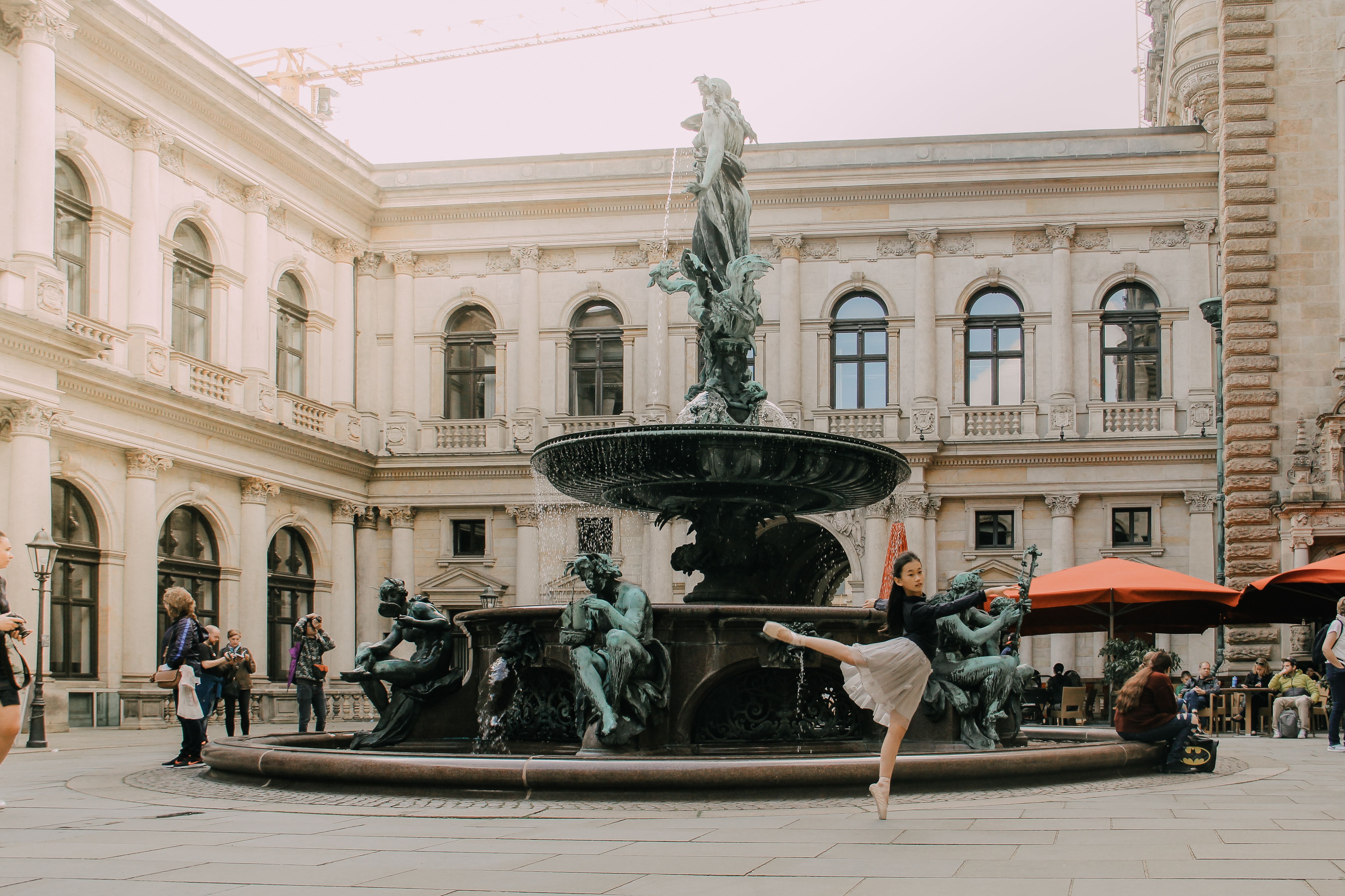 Ballerina Dancing near Fountain in City · Free Stock Photo