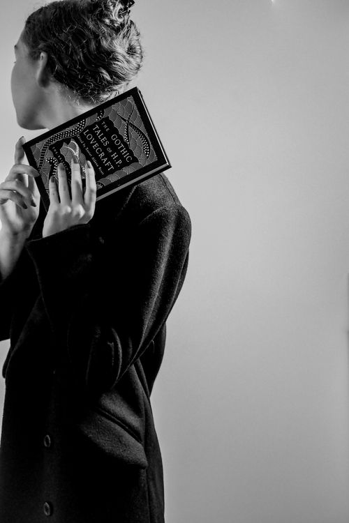 Free Elegant woman holding a book in monochrome fashion studio shot. Stock Photo
