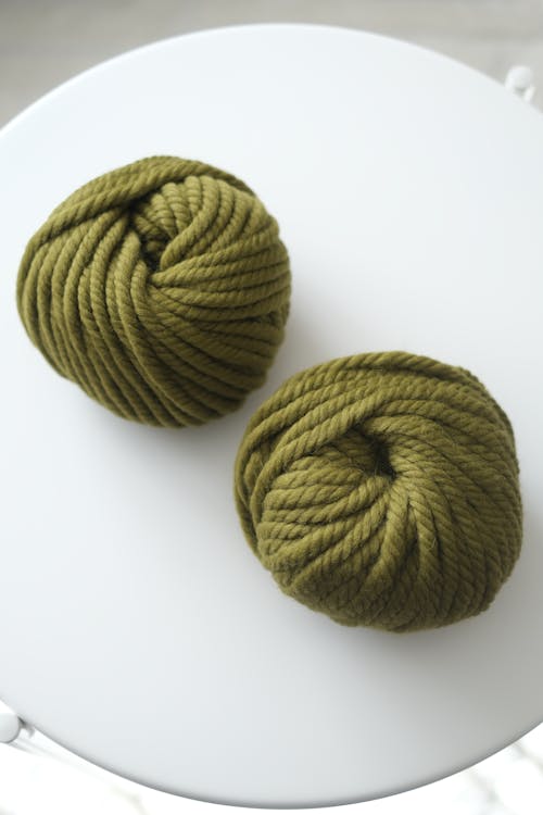 Two balls of yarn in olive green
