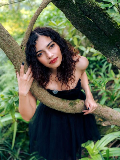 Free Beautiful portrait of a woman embracing nature in Sintra, Portugal's vibrant greenery. Stock Photo