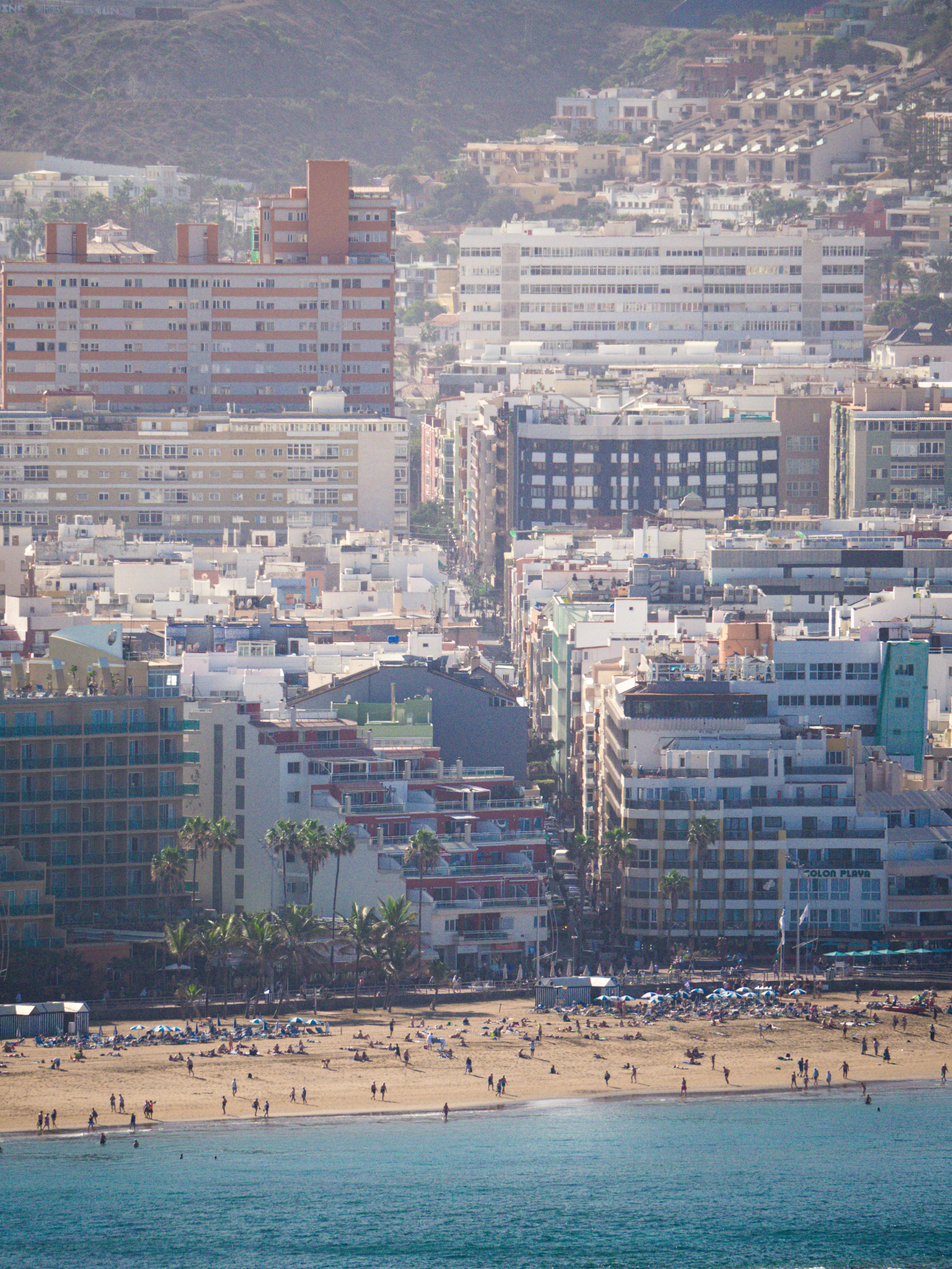 Aerial view of Las Palmas de Gran Canaria showcasing beachfront and urban landscape with vibrant city life.
