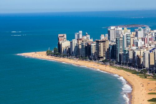 Free Aerial view of Vila Velha's coastline with skyscrapers and sandy beach, Brazil, vibrant summer scene. Stock Photo
