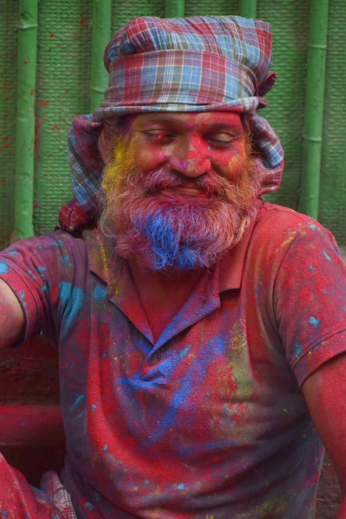 A man with a beard and colorful paint on his face