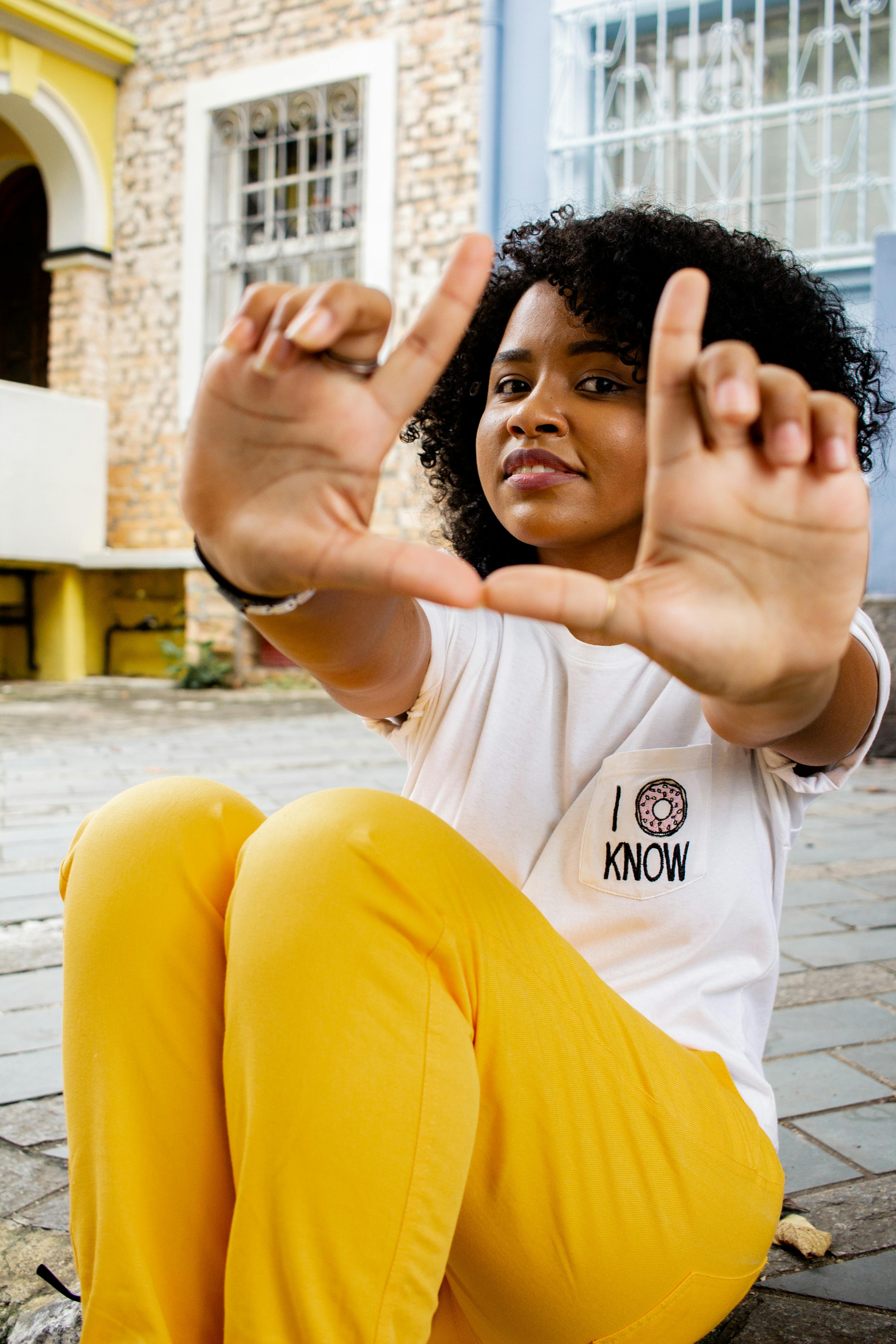 Woman wearing yellow shirt and black pants photo  Free Clothing Image on  Unsplash