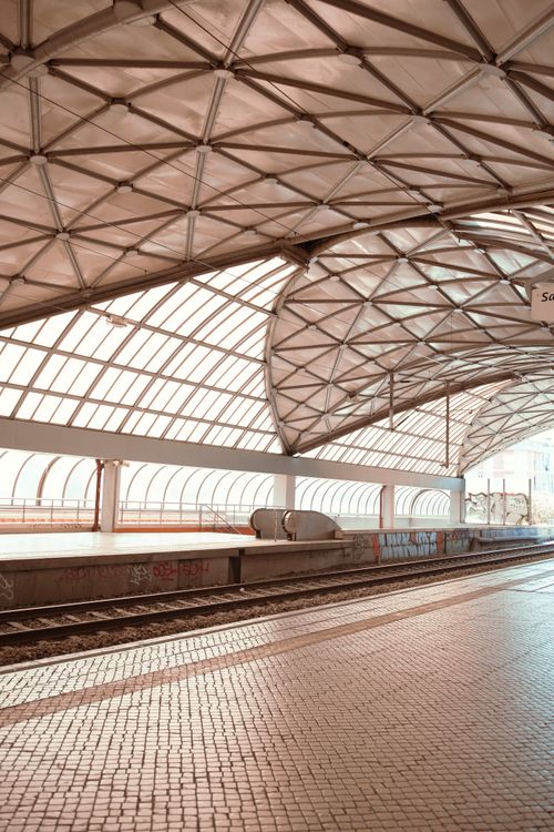 Free Spacious and empty urban railway station with steel and glass architecture, capturing modern transportation. Stock Photo
