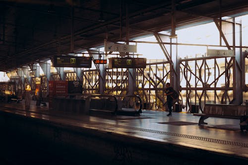 A train station with a train and people waiting