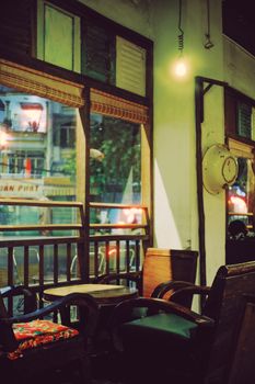 Charming café interior with vintage armchairs and warm lighting for a cozy ambiance.