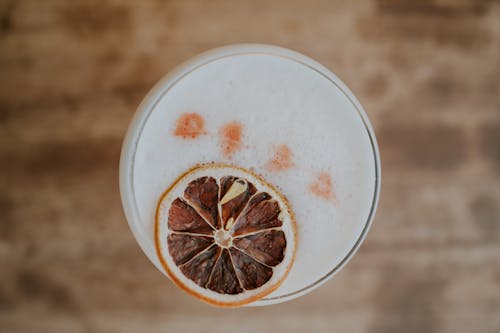 A close up of a drink with a slice of orange