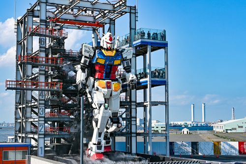 Free Life-sized Gundam robot at Gundam Factory Yokohama, Japan, in vibrant exterior daylight. Stock Photo