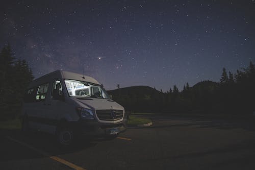 A van parked under a starry sky