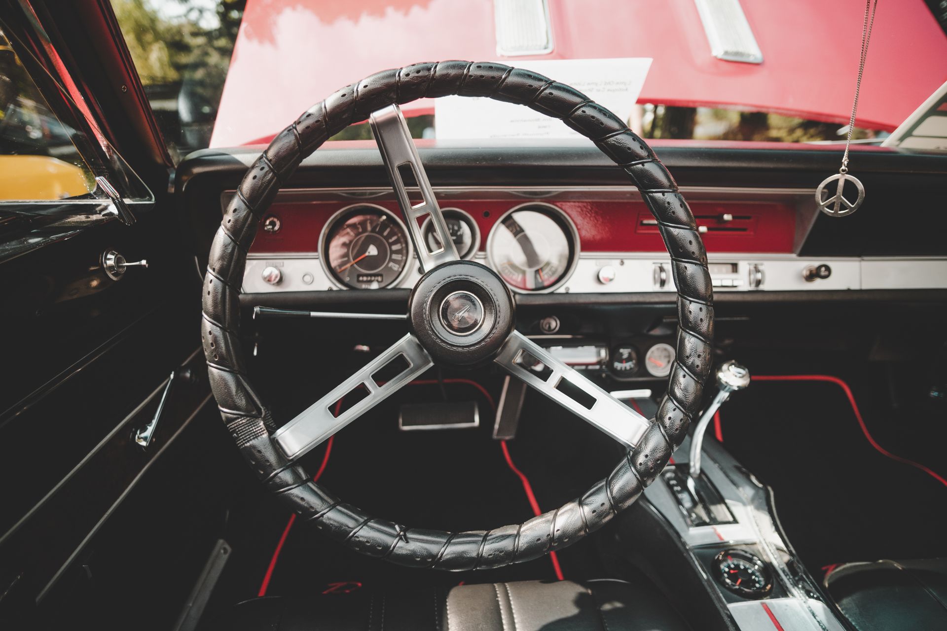 Close-up of a vintage Plymouth Barracuda car interior highlighting the dashboard and steering wheel.
