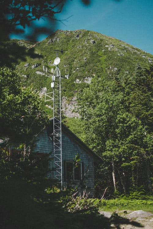 A house with a radio tower in the background