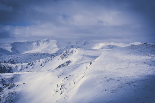 Grey Cloudy Sky over Snow Covered Mountain Ranges