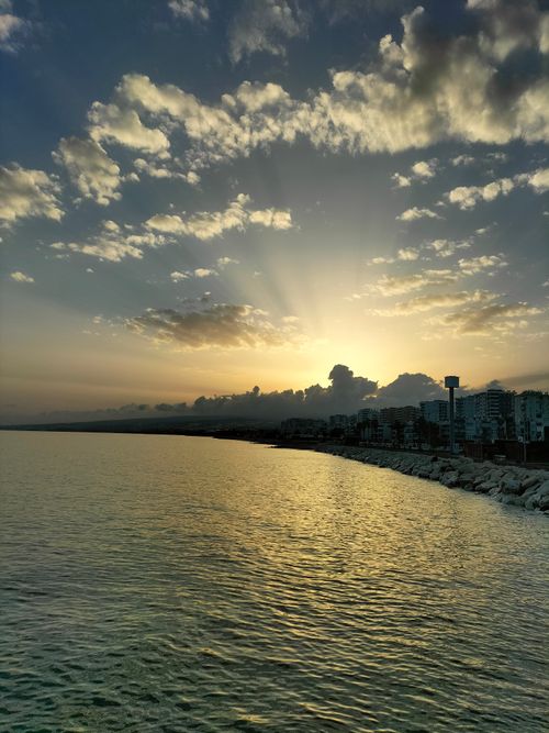 Free Serene sunrise view over Erdemli, Mersin coastline with vibrant skies and tranquil sea. Stock Photo