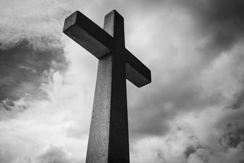 Free Low Angle Photo of Concrete Cross Under Clouds Stock Photo