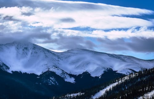 Mountain Covered With Snow Under White and Blue Skies