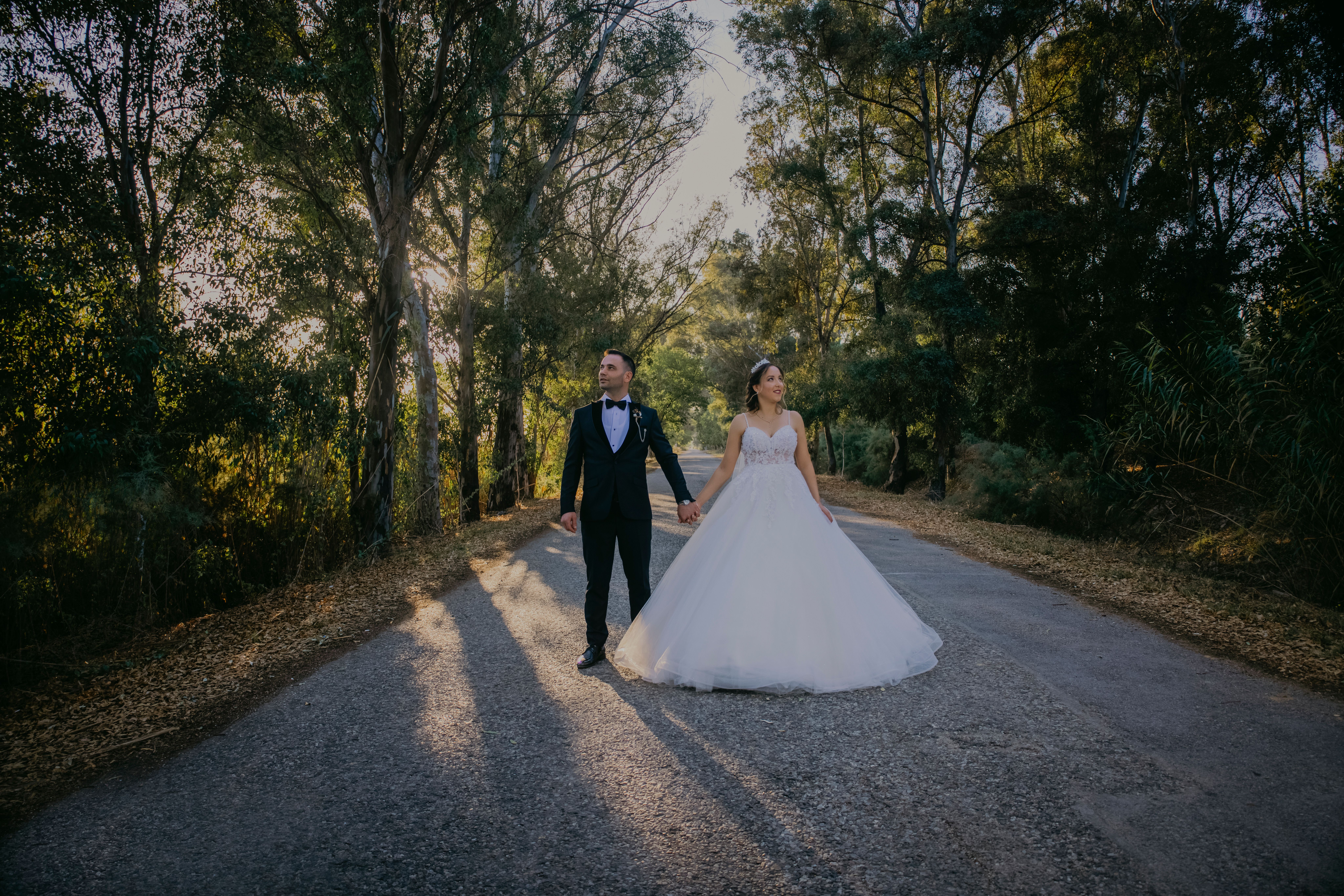 Married Couple Holding Hands and Walking Through a Park · Free Stock Photo