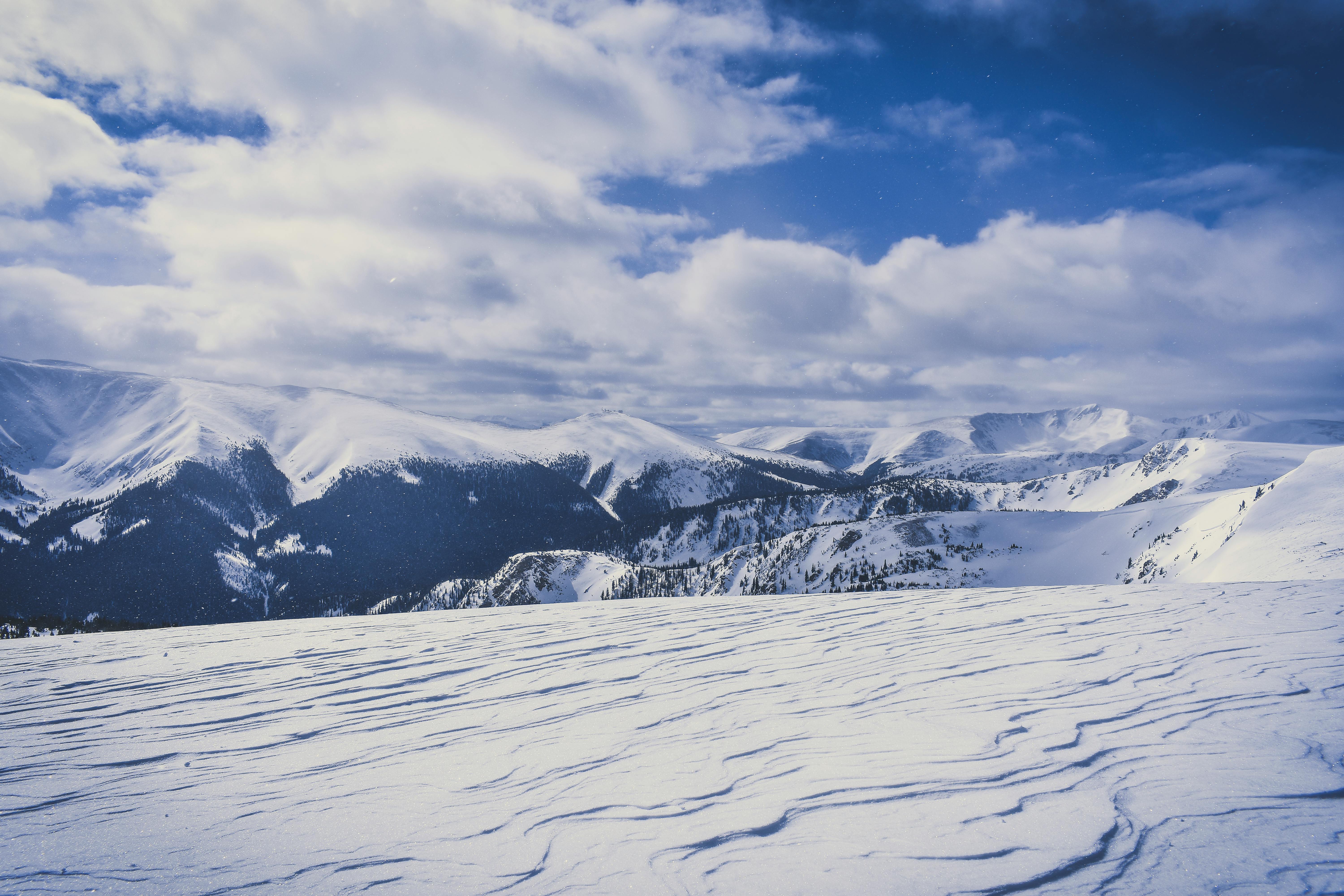 Snow Covered Hills Under White Clouds Free Stock Photo   Pexels Photo 2083176 