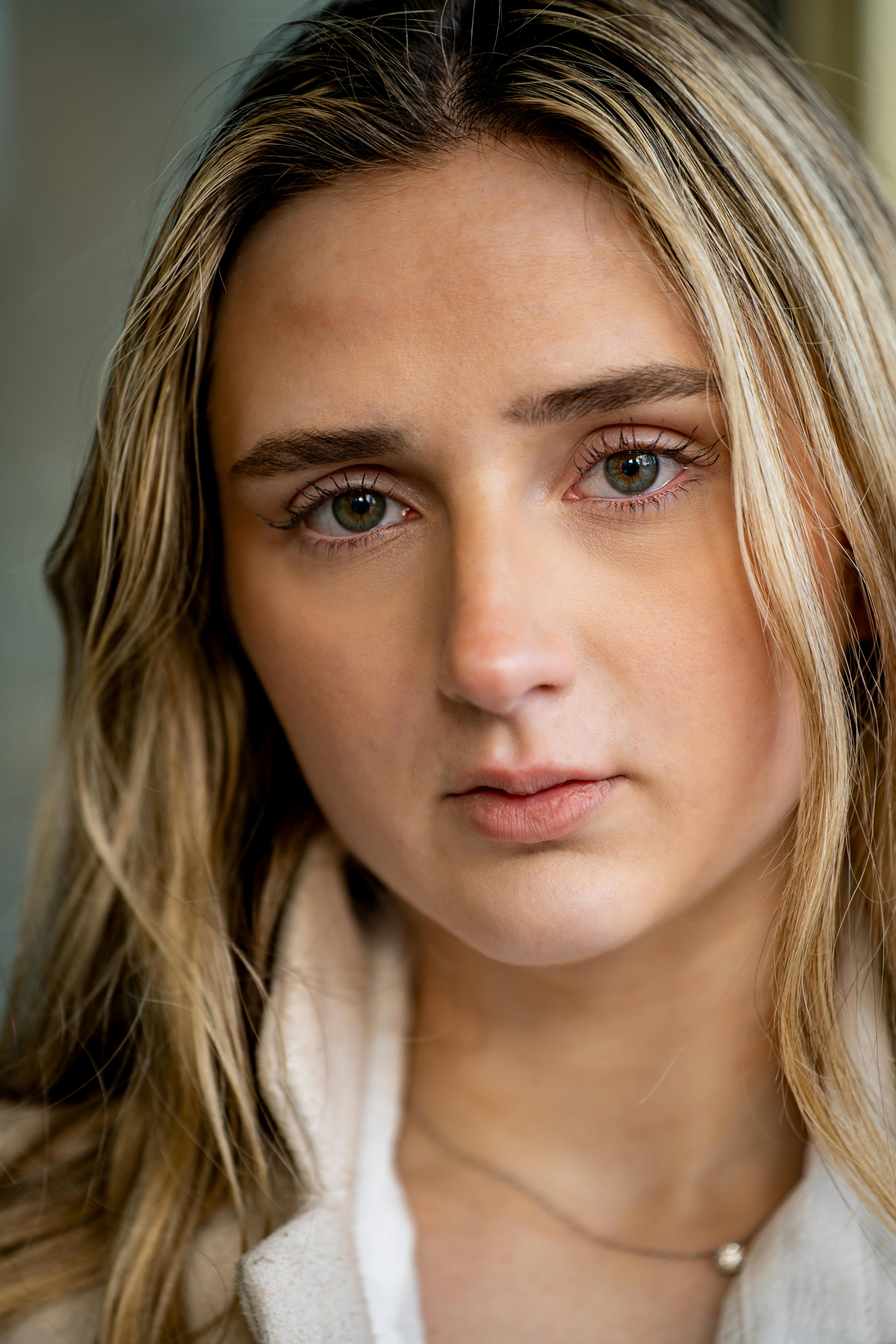 Intimate close-up portrait of a young woman with long blonde hair and natural beauty.
