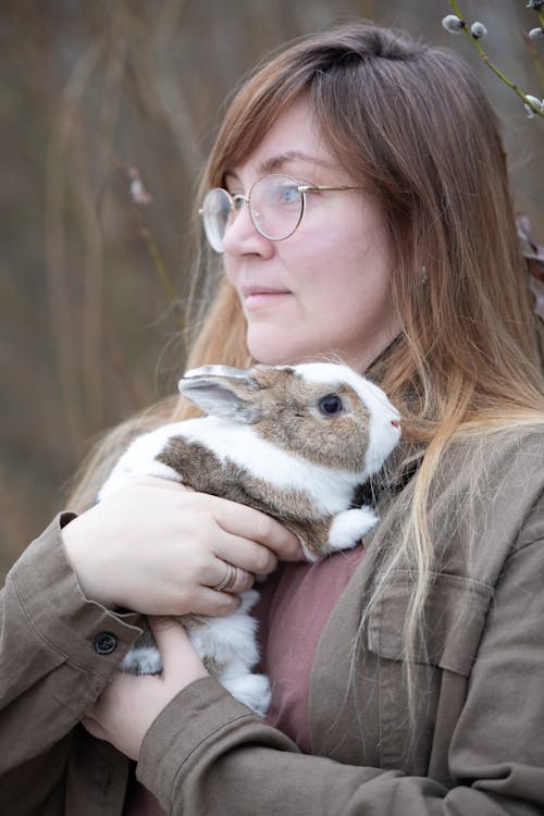 A woman holding a rabbit in her arms