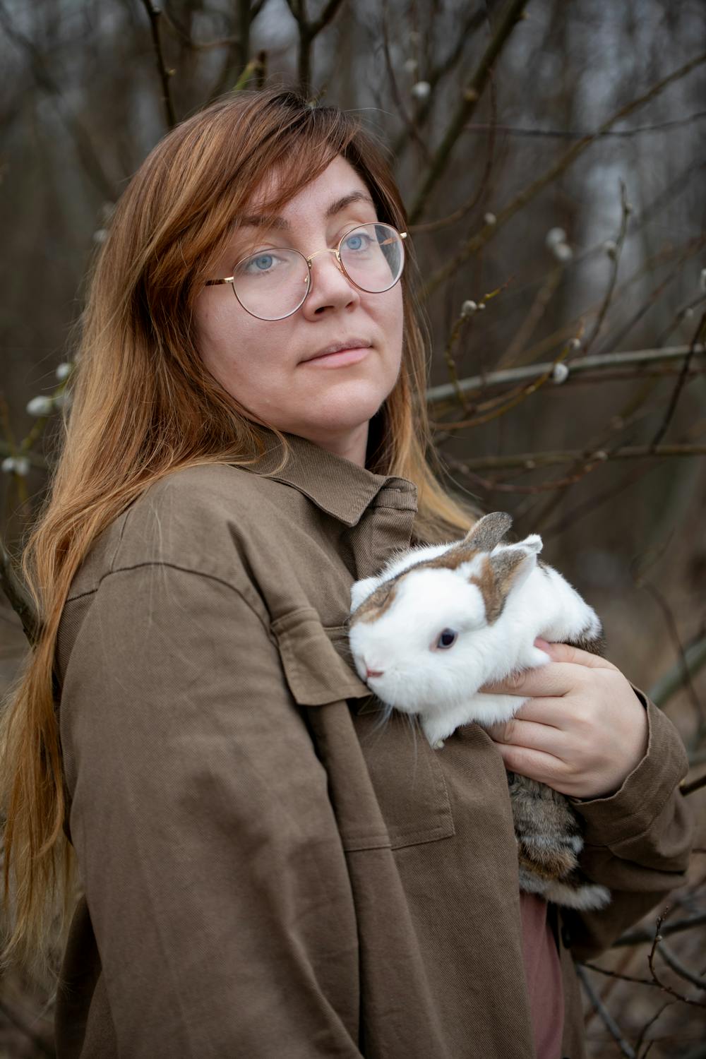 Woman with a Rabbit Posing by the Forest · Free Stock Photo