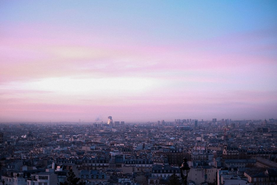 sunrise over Paris skyline, hopeful morning light on city rooftops