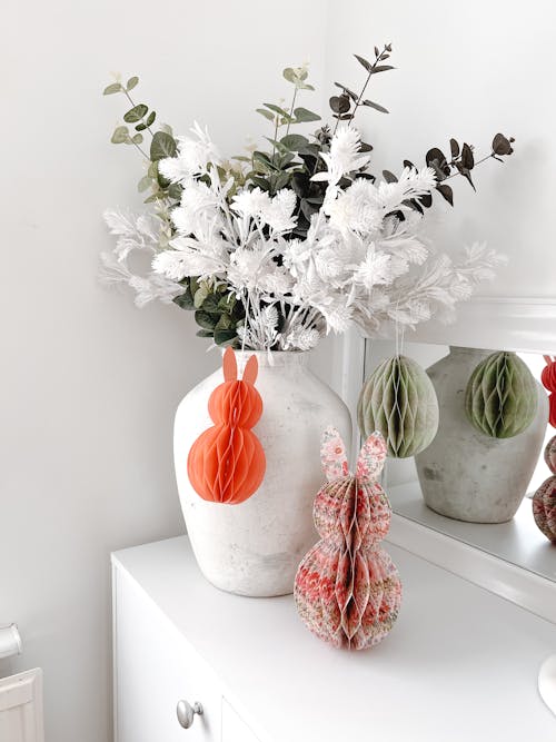 A vase with flowers and a vase with a white vase
