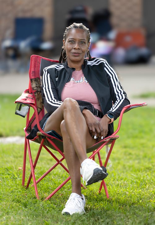 A woman sitting in a chair in the grass