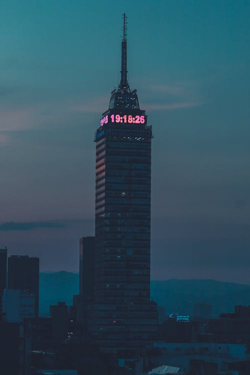 A tall building with a pink light on top