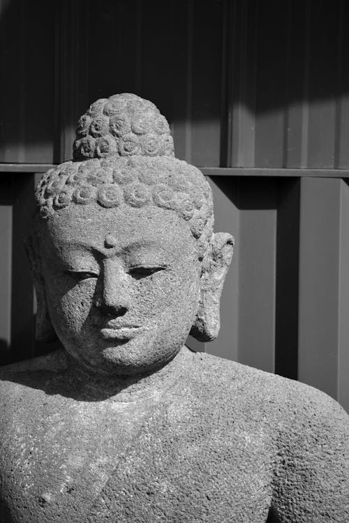 A black and white photo of a buddha statue