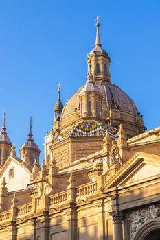Captivating view of Basilica del Pilar during sunset in Zaragoza, Spain featuring stunning architecture.