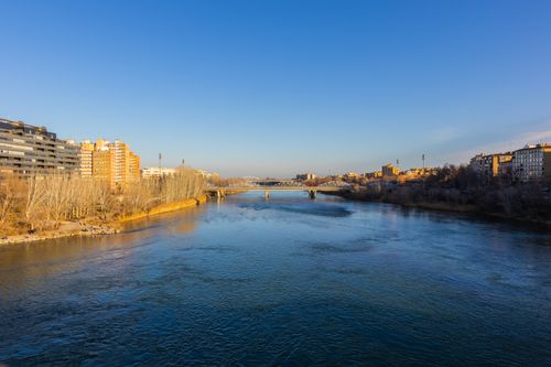 Free Beautiful Zaragoza cityscape with a river and bridge on a sunny day. Stock Photo