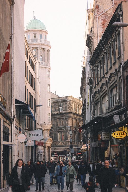 Free View of a busy street in Istanbul featuring a historic tower and lively pedestrian activity. Stock Photo