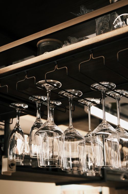 Free Chic display of hanging wine glasses in an upscale restaurant bar. Stock Photo
