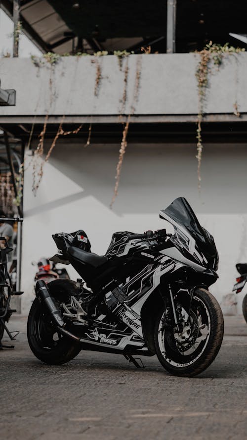 A black and white motorcycle parked in front of a building