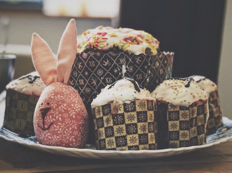 Easter kulich with icing and a bunny plushie, perfect for festive celebrations in Moscow.