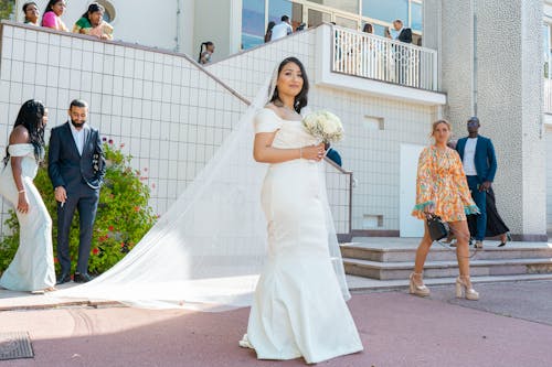 A bride and groom walking down the steps of a building