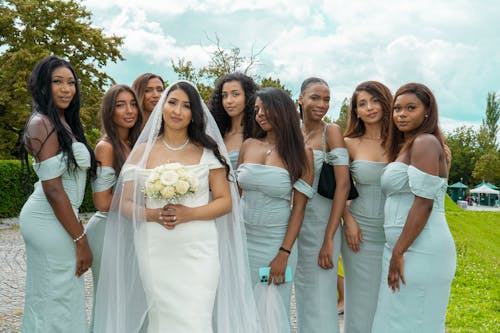 A bride and her bridesmaids pose for a photo