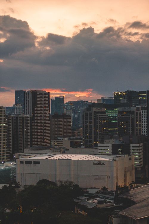 Free A stunning cityscape with high-rise buildings during a dramatic sunset, showcasing urban architecture. Stock Photo