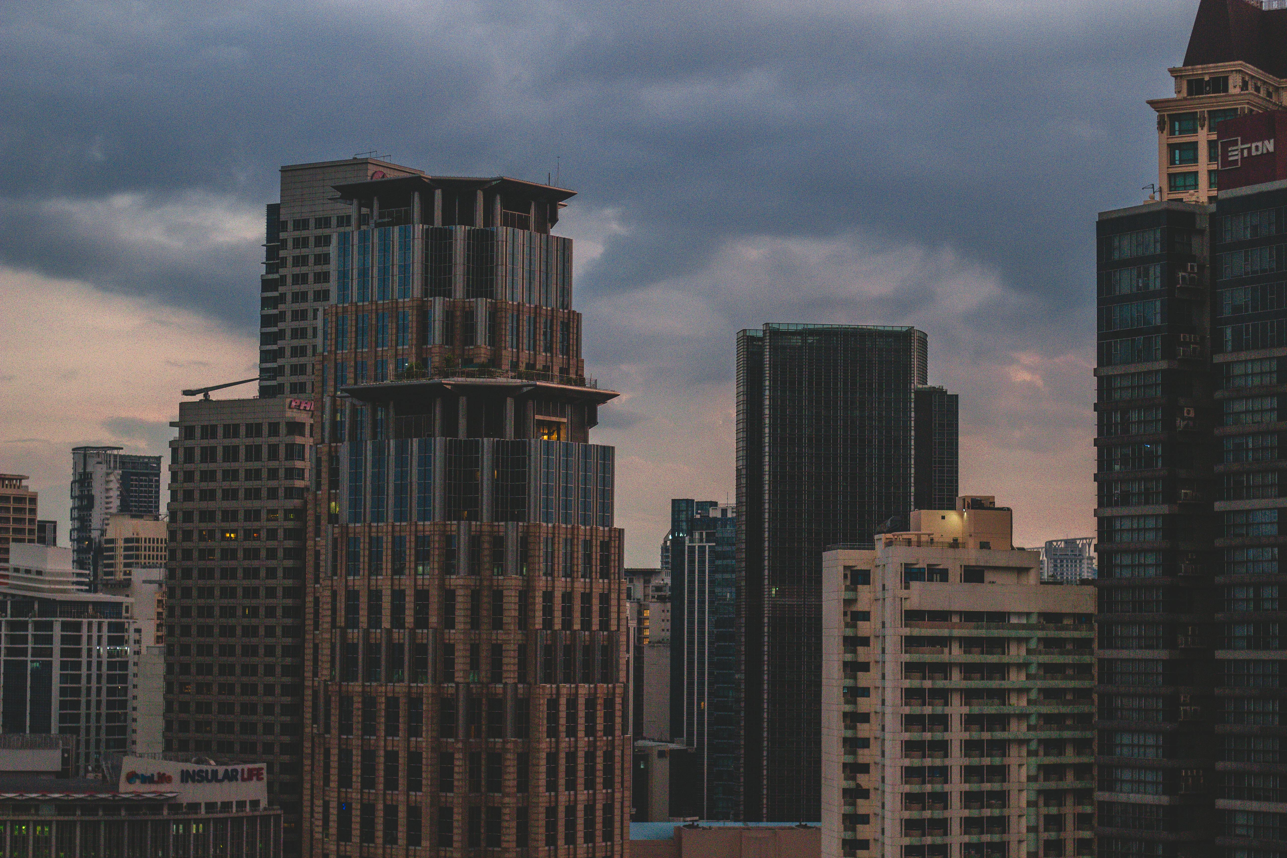 A dramatic view of Makati's skyline with towering skyscrapers at dusk.