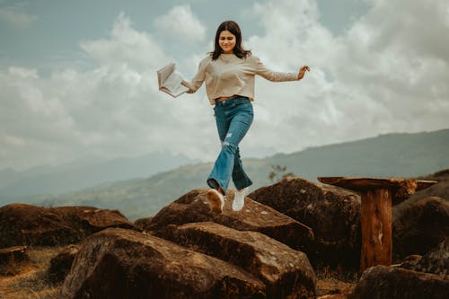 Free Fly girl Jumping Rocks in Mountains Cinematic Pose 