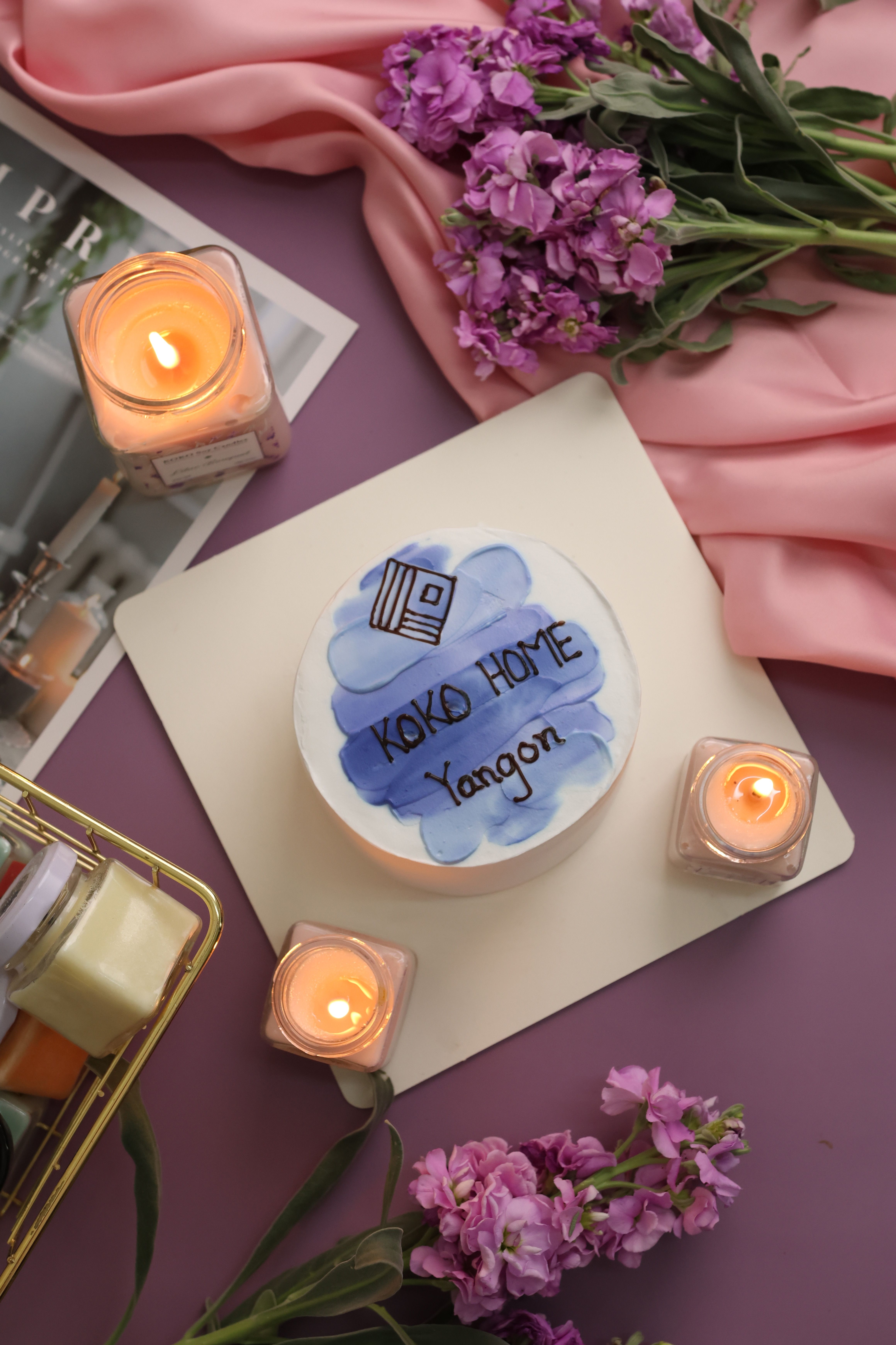 Beautifully decorated cake with candles and flowers, ideal for a cozy celebration or intimate setting.