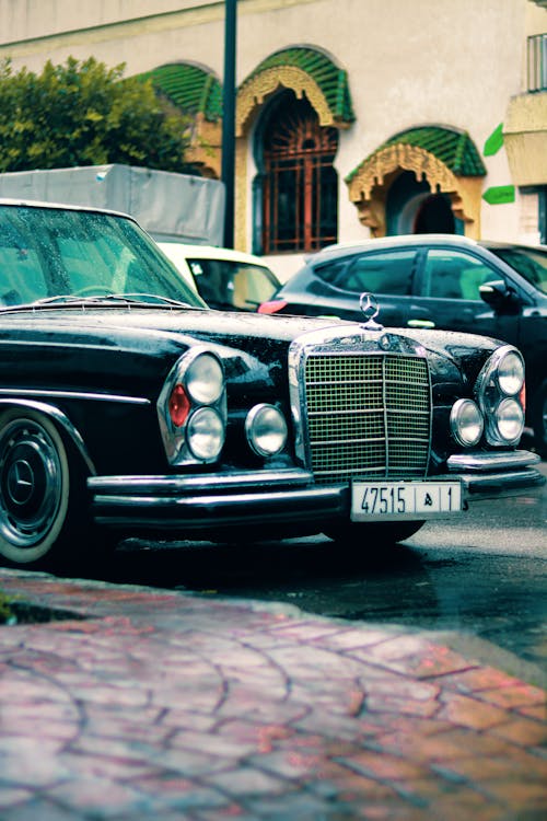 A black mercedes benz parked on the side of the road