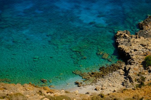 Free A breathtaking aerial view of a rocky tropical coastline with clear turquoise water. Stock Photo
