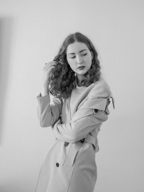 A woman in a trench coat posing for a photo