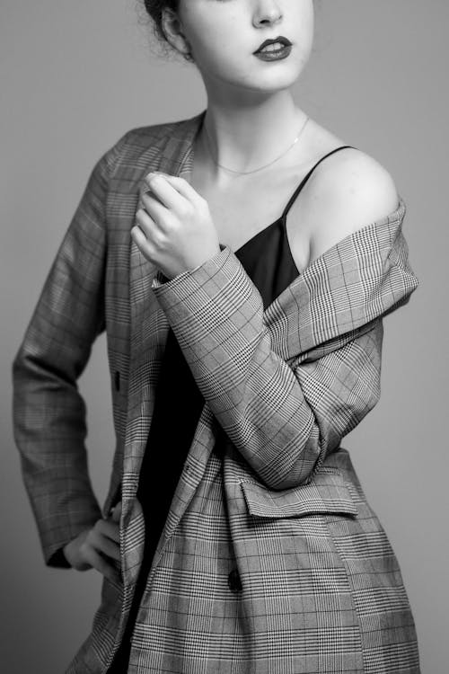 Woman in Coat and Dress Posing in Studio