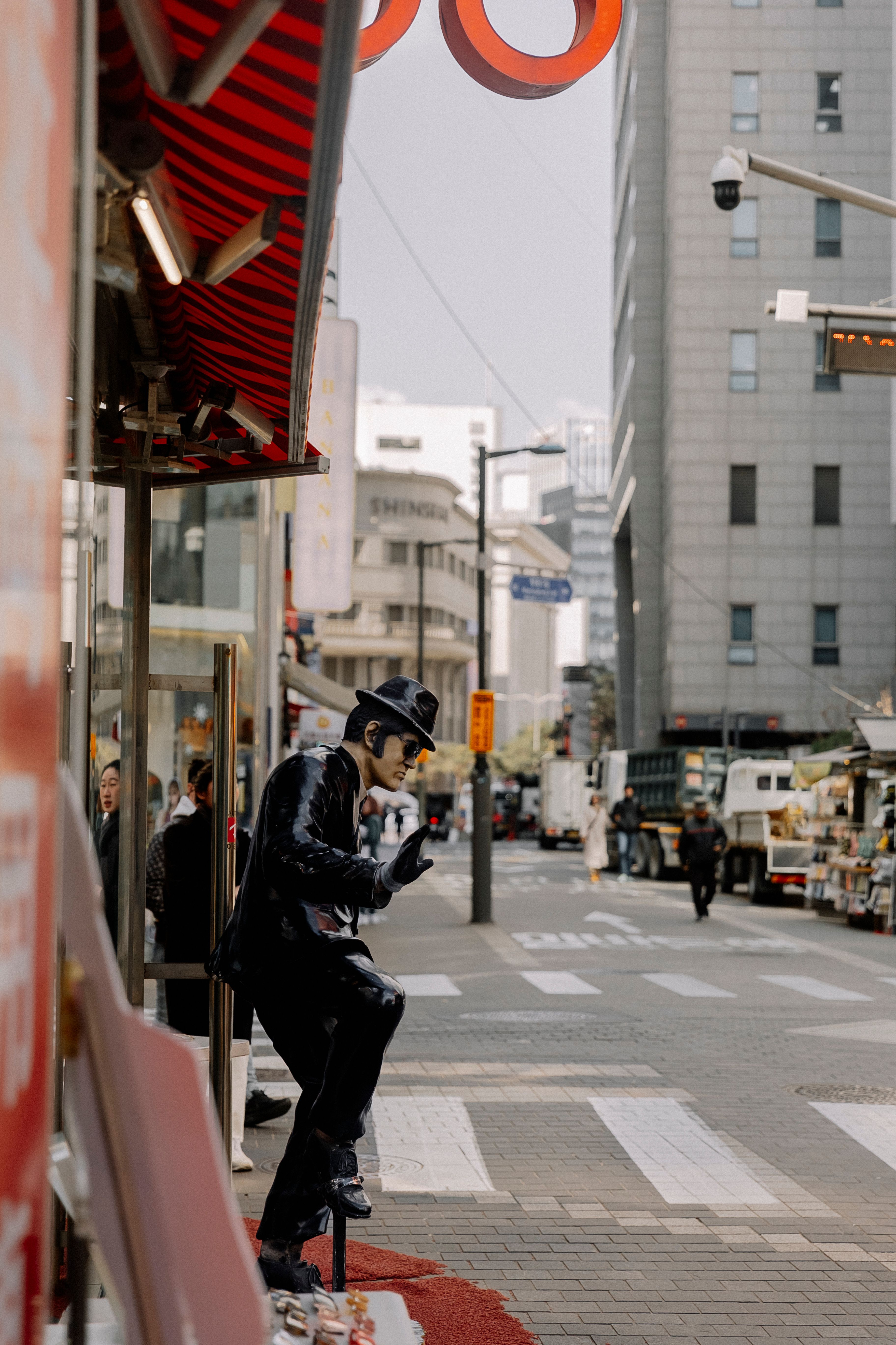 A Statue of a Man Standing Outside of a Building in a City · Free Stock ...