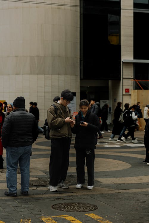 A group of people standing in a city street