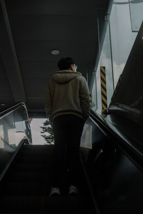 A person walking down an escalator