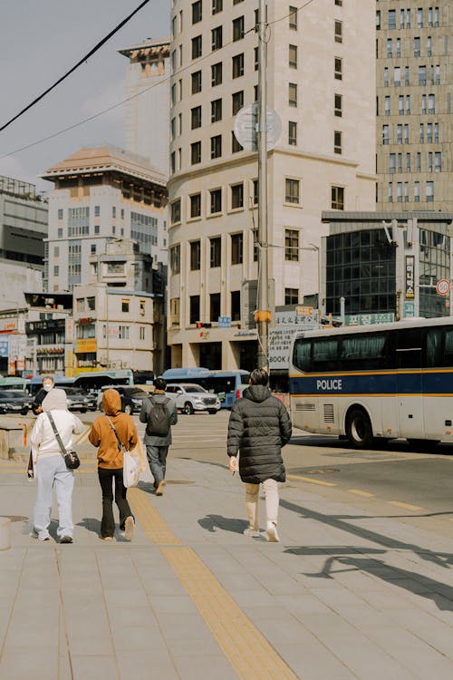 A group of people walking down a city street